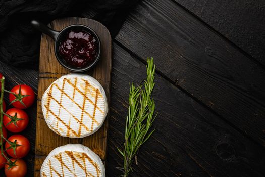 Oven Backed camembert, on black wooden table background, top view flat lay, with copy space for text
