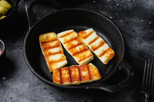 Grilled Halloumi, fried cheese set, on black dark stone table background