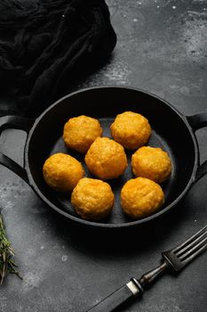 Battered meat, on black dark stone table background