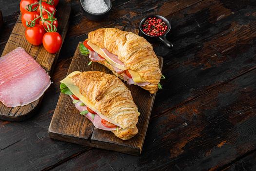 Croissant with ham set, with herbs and ingredients, on old dark wooden table background, with copy space for text