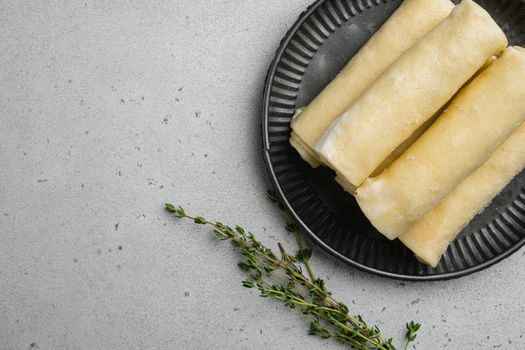 Frozen pancakes with meat, on gray stone table background, top view flat lay, with copy space for text