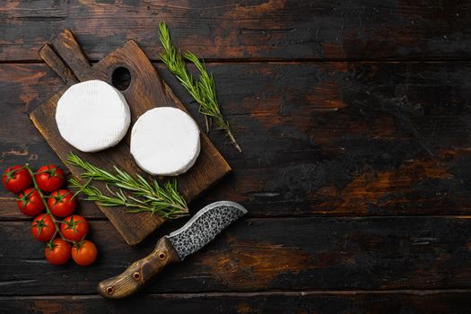 Fresh Brie cheese, on old dark wooden table background, top view flat lay, with copy space for text