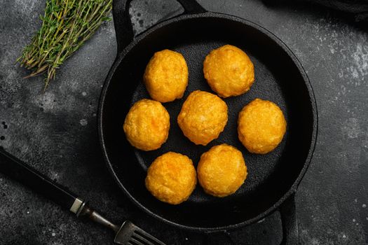 Battered sausage meat ball, on black dark stone table background, top view flat lay