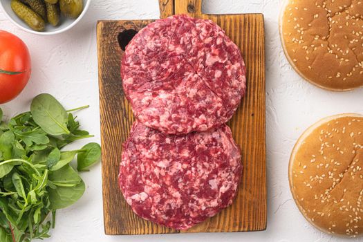 Raw Minced Steak Burgers from Beef Meat set, on white stone background, top view flat lay