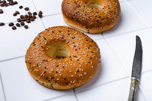 Bagel Freshly Baked, on white ceramic squared tile table background