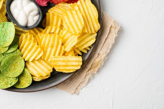 Crispy potato chips, on white stone table background, top view flat lay, with copy space for text