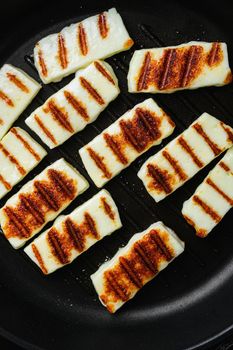 Grilling Halloumi Cheese set, on old dark rustic table background, top view flat lay