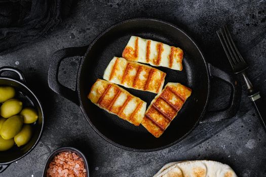 Halloumi fried cheese set, on black dark stone table background, top view flat lay