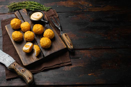 Battered meatballs, on old dark wooden table background, with copy space for text