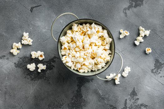 Olive oil popped popcorn, on gray stone table background, top view flat lay, with copy space for text