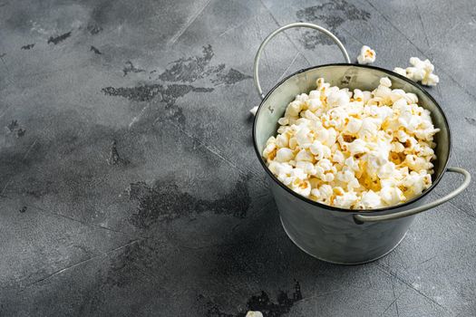 Salted popcorn, on gray stone table background, with copy space for text