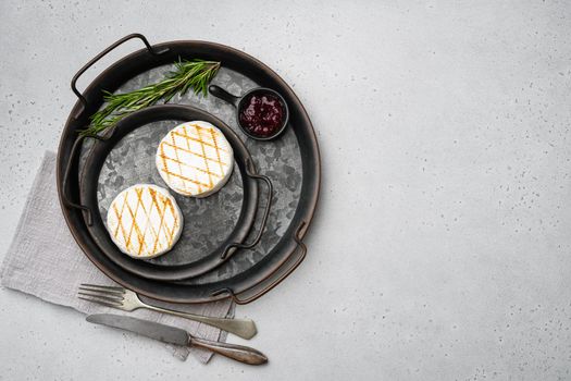 Grilled camembert or brie cheese, on gray stone table background, top view flat lay, with copy space for text