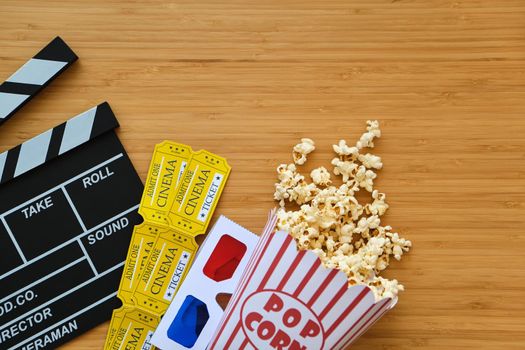 clapper board, movies tickets and popcorn. Movie top view on red background with copy space