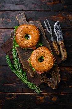 Cream cheese and smoked salmon bagel set, on old dark wooden table background, top view flat lay