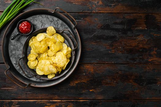 Limon Flavored Potato Chips, on old dark wooden table background, top view flat lay, with copy space for text