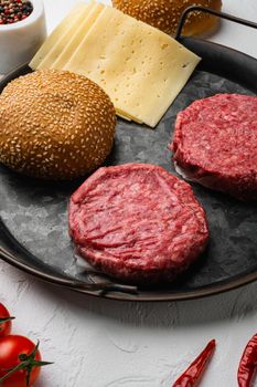 Raw BBQ Beef Burger Cutlets, on white stone table background