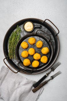 Breaded chicken fillet and batter, on gray stone table background, top view flat lay