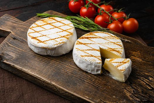 Oven Backed camembert, on old dark wooden table background