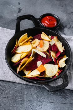 Beetroot carrot and turnip chips set, on gray stone table background