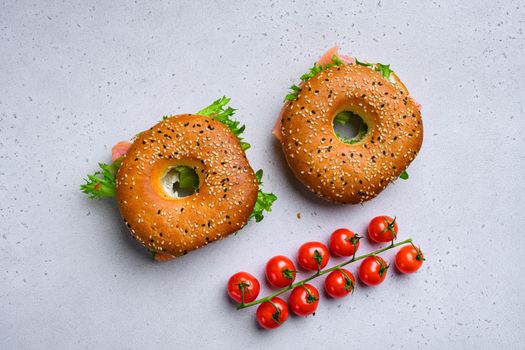 Cream cheese and smoked salmon bagel set, on gray stone table background, top view flat lay