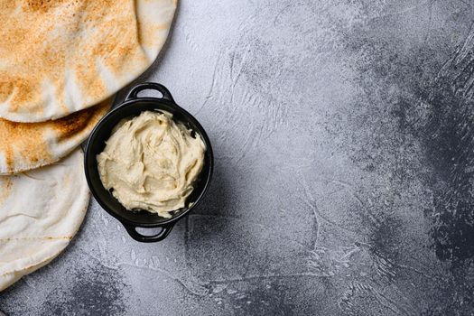 Healthy Creamy Hummus, on gray stone table background, top view flat lay, with copy space for text