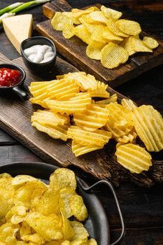 Salt Vinegar Flavored Potato Chips, on old dark wooden table background