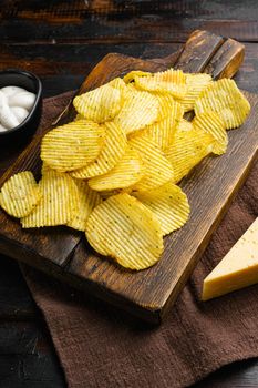 Wavy Ranch Flavored Potato Chips, on old dark wooden table background