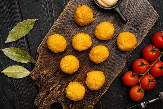 Battered meatballs, on black wooden table background, top view flat lay