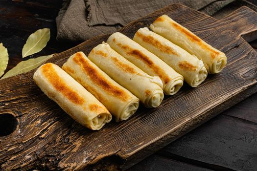Georgian crepes stuffed, on old dark wooden table background