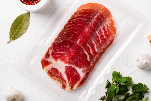 Cured meat coppa pack set, on white stone table background, top view flat lay