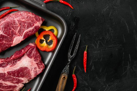 Meat steak set, on black dark stone table background, top view flat lay, with copy space for text