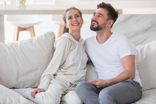 Couple relaxing in living room and smiling