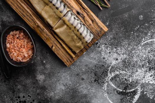 Smoked mackerel set, on black dark stone table background, top view flat lay, with copy space for text