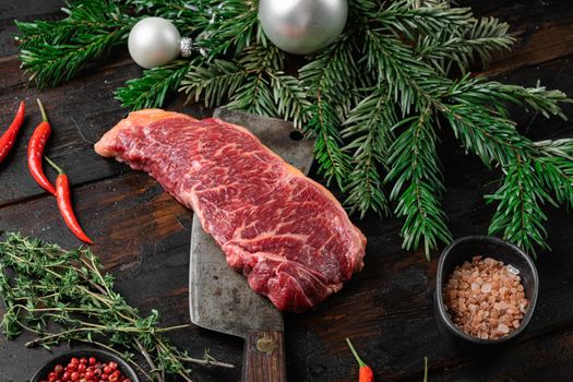 Raw Striploin marbled beef steak for the new year set, on old dark wooden table background