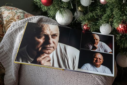 family photo book near the Christmas tree.