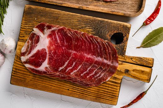 Italian cured meat slices coppa set, on white stone table background, top view flat lay