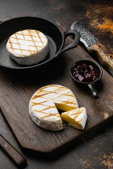 Oven Backed camembert, on old dark rustic table background