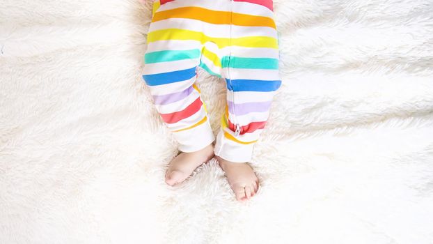 baby feet on a white background bed. Selective focus. Child.