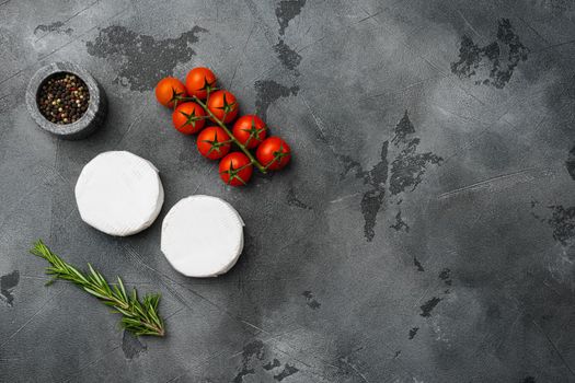 Camembert and brie cheese, on gray stone table background, top view flat lay, with copy space for text