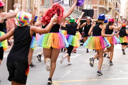 Santa Pola, Alicante, Spain- July 2, 2022: Group of dancers performing at the Gay Pride Parade in Santa Pola town, Alicante, Spain
