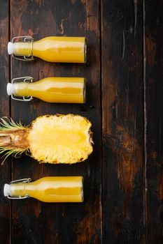 Pineapple juice set, on old dark wooden table background, top view flat lay, with copy space for text