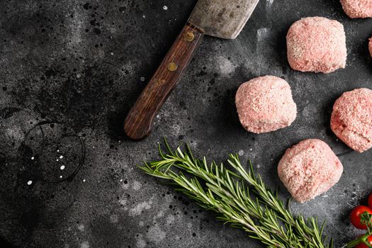 Home made raw meatballs set, on black dark stone table background, top view flat lay, with copy space for text