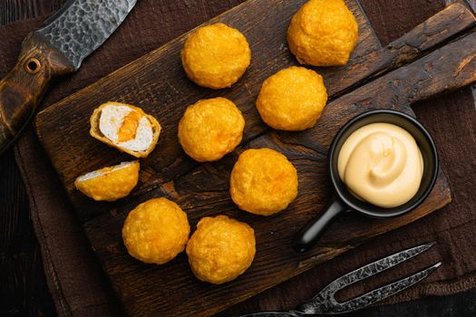 Breaded chicken fillet and batter, on old dark wooden table background, top view flat lay