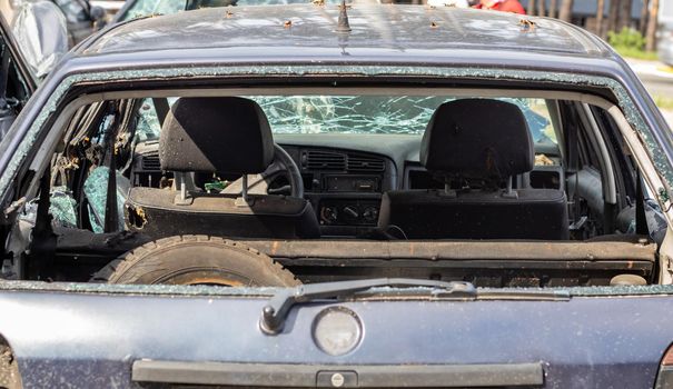 A car after an accident with a broken rear window. Broken window in a vehicle. The wreckage of the interior of a modern car after an accident, a detailed close-up view of the damaged car