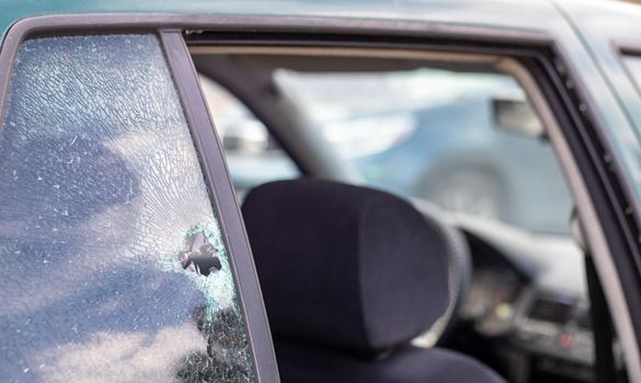 Car riddled with bullets. War of Russia against Ukraine. A car of civilians shot by the Russian military during the evacuation of women and children. Traces of bullets and fragments of shells