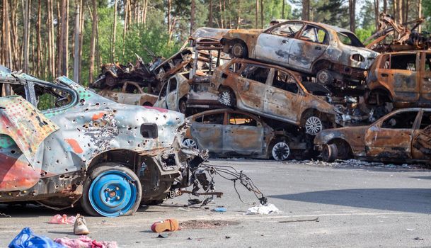 Shot, damaged cars during the war in Ukraine. The civilian car was damaged. Shrapnel and bullet holes in the car body. Car riddled with bullets. Bullet holes and shell fragments