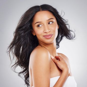 Cropped shot of an attractive young woman posing in studio against a grey background.