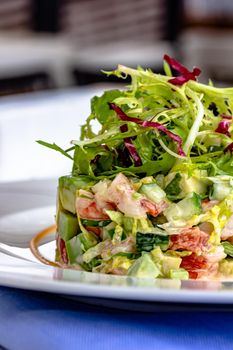Layer Salad with Shrimps, Crab and Avocado in Luxury Restaurant.