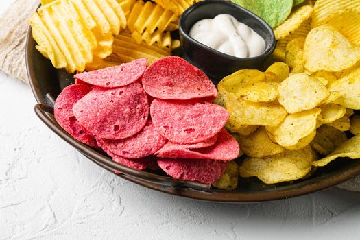 Variation different potato chips, on white stone table background