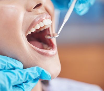 Shot of a woman about to have her teeth checked by the dentist.